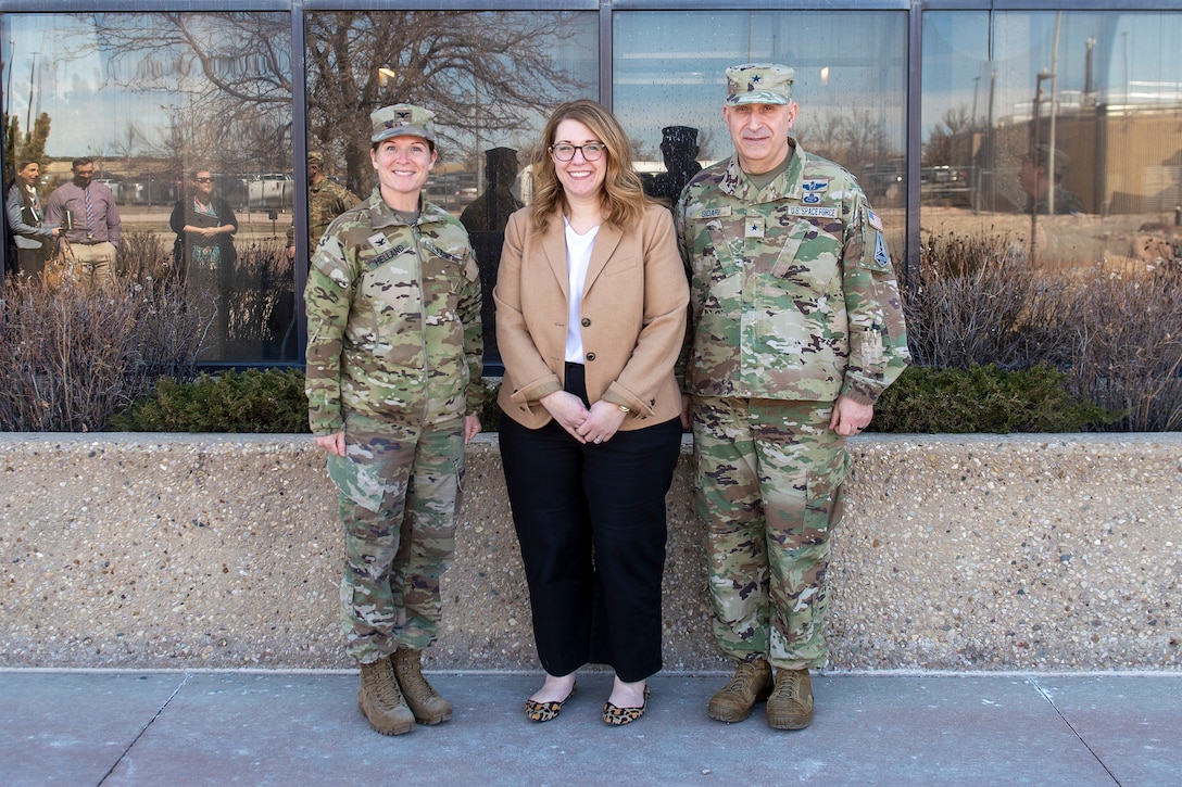 Three people pose for group photo