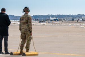 Airman 1st Class Jaxon Jeffries, 934th Aircraft Maintenance Squadron crew chief, positions chalks for Air Force One at Minneapolis-St. Paul Air Reserve Station, April 3, 2023. (U.S. Air Force photo by Master Sgt. Trevor Saylor)