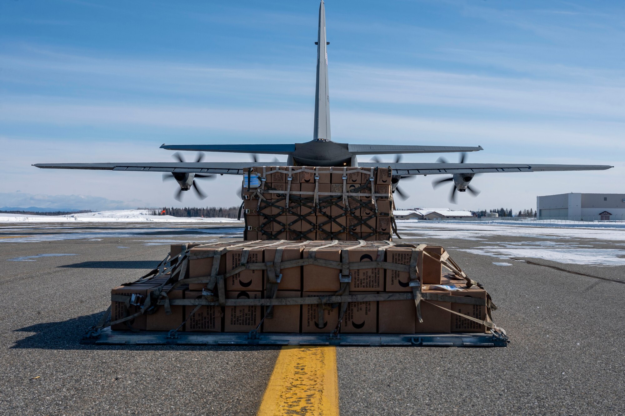 Cargo sits outside of a C-130J Super Hercules