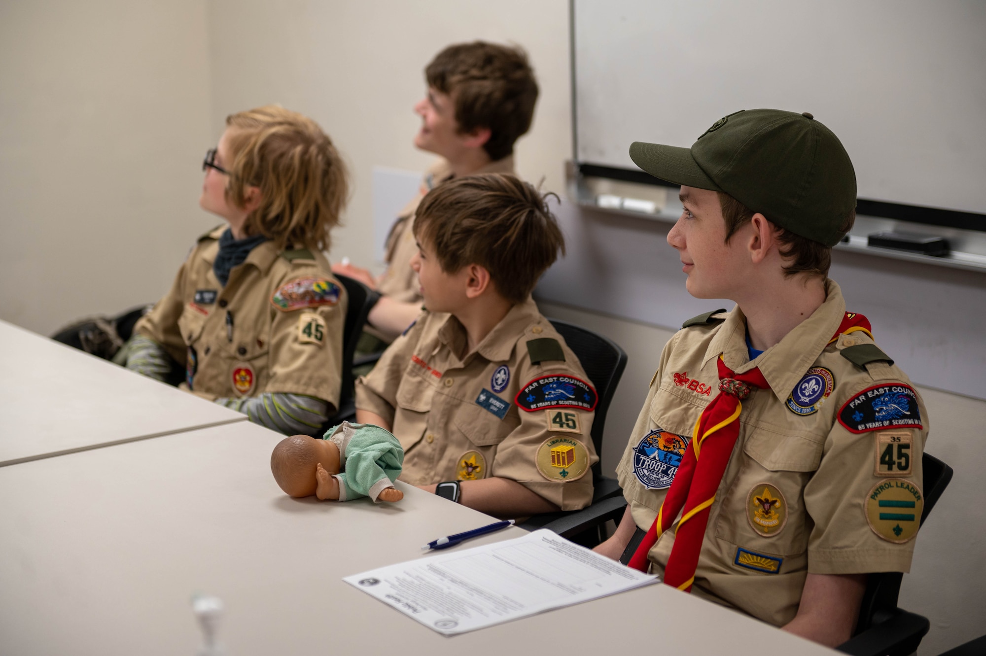 Boy Scouts of America Troop 45 members listen intently to a public health brief at Yokota Air Base, Japan, April 4, 2023. In recognition of National Public Health Week, Yokota’s Public Health clinic hosted this class to help the scouts earn their Public Health Merit Badge, signifying that they understand the impact of maintaining and monitoring the health of their community. (U.S. Air Force photo by Airman 1st Class Natalie Doan)