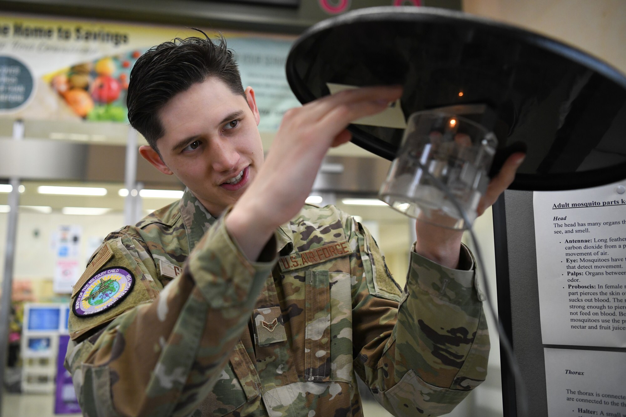 Airman 1st Class D-Jay Gangano, 374th Operational Medical Readiness Squadron communicable disease program lead, shows a mosquito trap in front of an entomology display at Yokota Air Base, Japan, April 6, 2023. As part of National Public Health week, Yokota’s Public Health clinic put on an entomology display to show how insects are caught and tested for infectious diseases. (U.S. Air Force photo by Staff Sgt. Spencer Tobler)