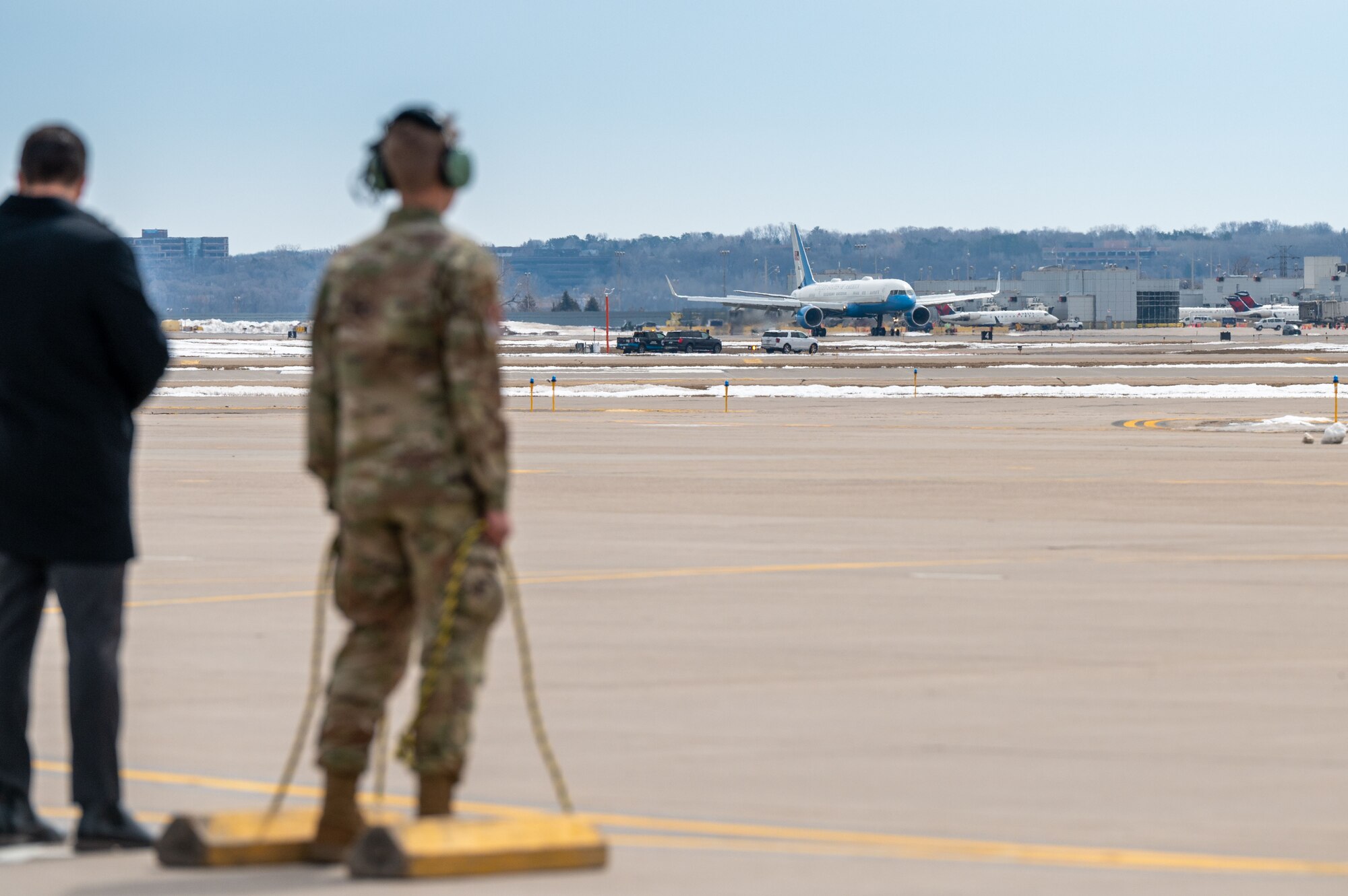 Airman 1st Class Jaxon Jeffries, 934th Aircraft Maintenance Squadron crew chief, watches Air Force One land at Minneapolis-St. Paul Air Reserve Station, April 3, 2023. Jeffries was chosen to place chalks at the aircraft. (U.S. Air Force photo by Master Sgt. Trevor Saylor)