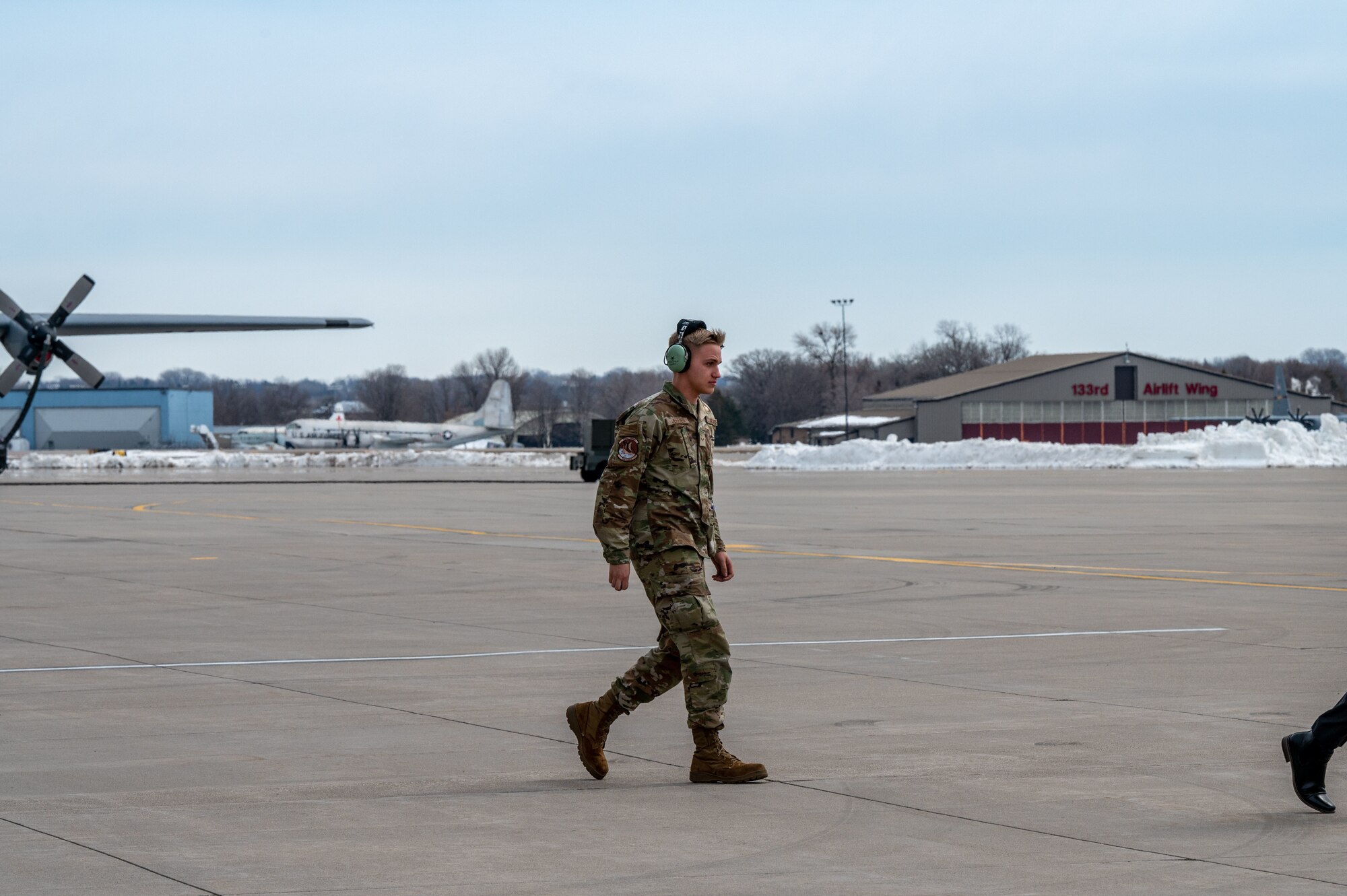 Airman 1st Class Jaxon Jeffries, 934th Aircraft Maintenance Squadron crew chief, walks on the flight line toward Air Force One, after landing at Minneapolis-St. Paul Air Reserve Station, April 3, 2023. (U.S. Air Force photo by Master Sgt. Trevor Saylor)
