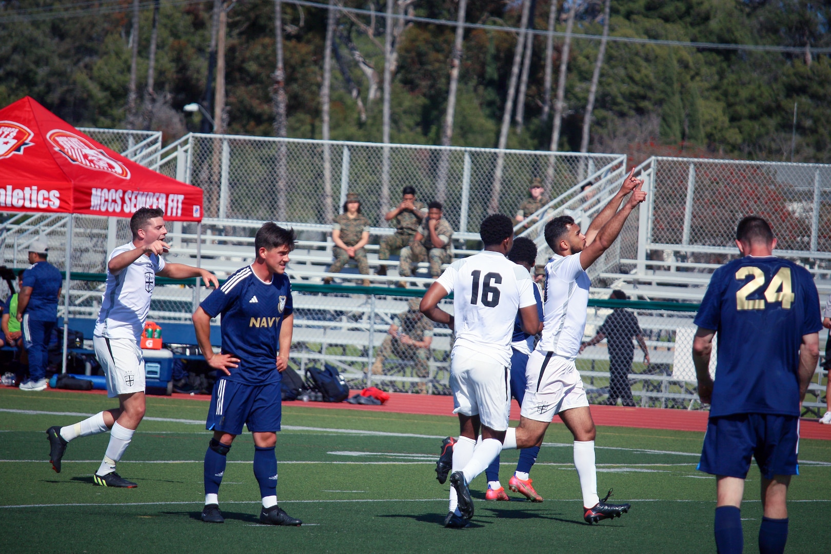 Airman 1st Class Isaac De Souza of Ramstein Air Base, Germany raises his arms after scoring the winning goal during match 2, featuring Navy v Air Force, of the 2023 Armed Forces Men’s Soccer Championship held at the Paige Fieldhouse Marine Corps Base Camp Pendleton, California on 5 April 2023.  The Armed Forces Men's Soccer Championship hosted by Marine Corps Base Camp Pendleton, California from April 4-11.  The Armed Forces Championship features teams from the Army, Marine Corps, Navy (with Coast Guard runners), and Air Force (with Space Force Runners).  Department of Defense Photo by Mr. Steven Dinote - Released.