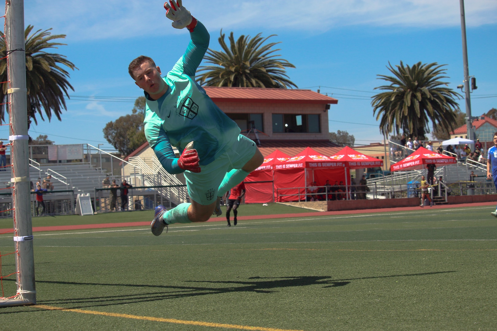 Air Force goalie Senior Airman Gavin Bryant of Langley AFB, Virginia dives to save a goal during match 4 featuring USMC v USAF of the 2023 Armed Forces Men’s Soccer Championship held at the Paige Fieldhouse Marine Corps Base Camp Pendleton, California on 7 April 2023.  The Armed Forces Men's Soccer Championship hosted by Marine Corps Base Camp Pendleton, California from April 4-11.  The Armed Forces Championship features teams from the Army, Marine Corps, Navy (with Coast Guard runners), and Air Force (with Space Force Runners).  Department of Defense Photo by Mr. Steven Dinote - Released.