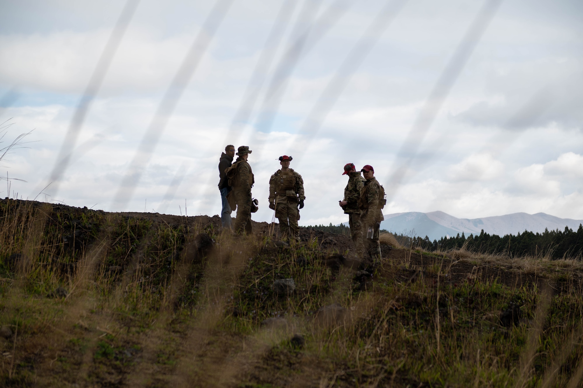 Service members congregate before the start of an M249 Squad Automatic Weapon sustainment firing.