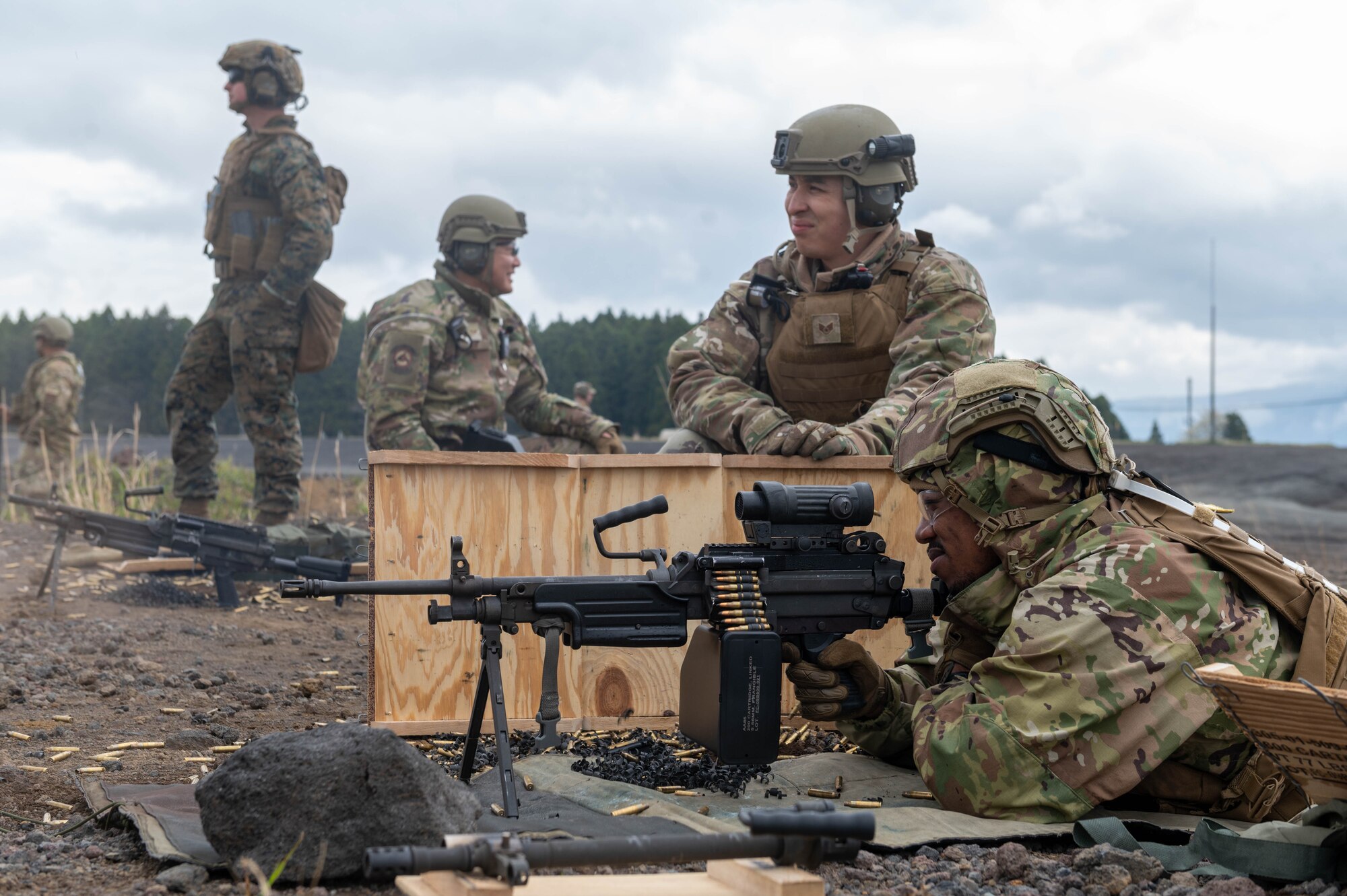 Service members participate in an M249 Squad Automatic Weapon sustainment firing.