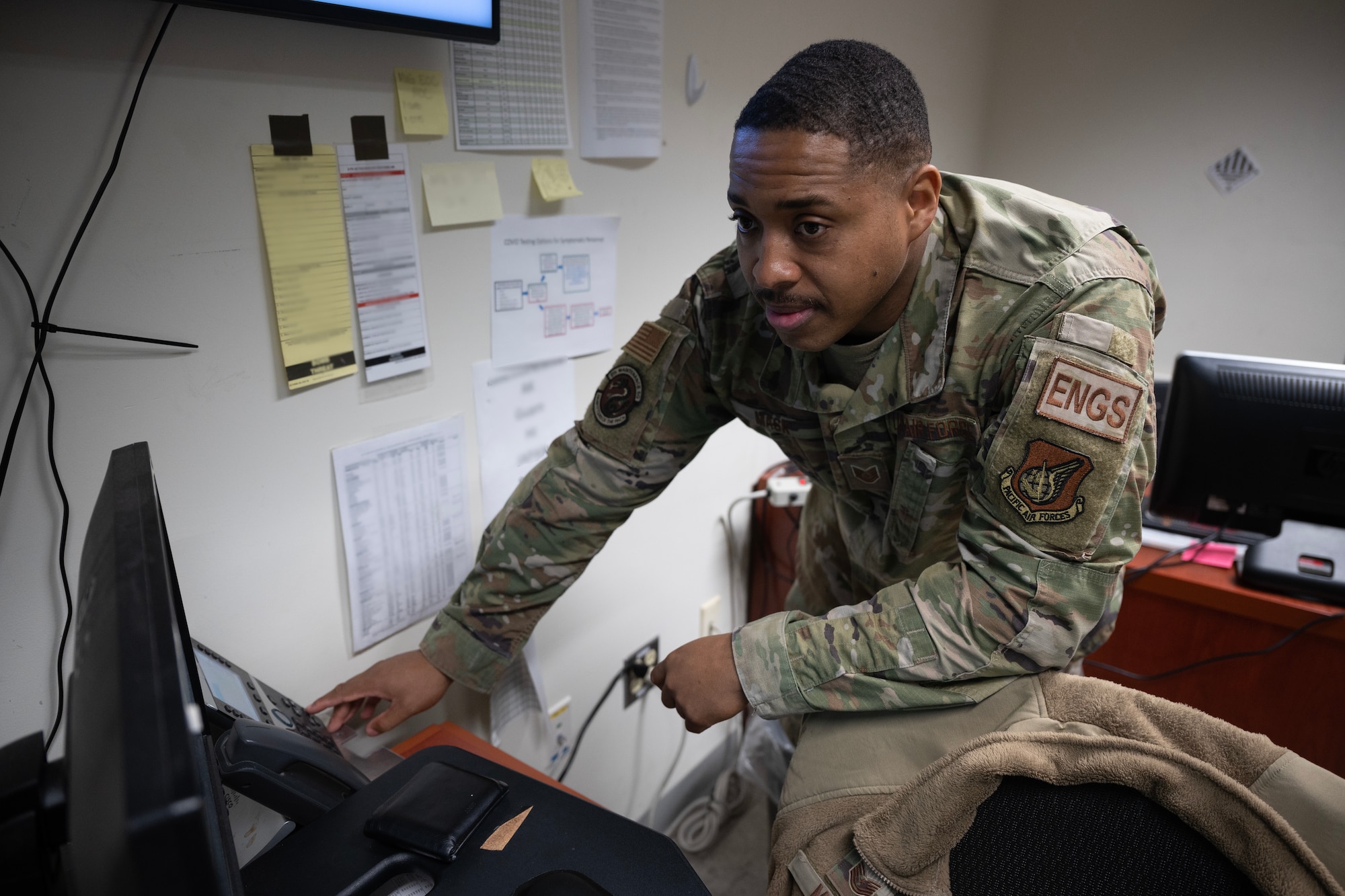 An Airman listens to his phone call.