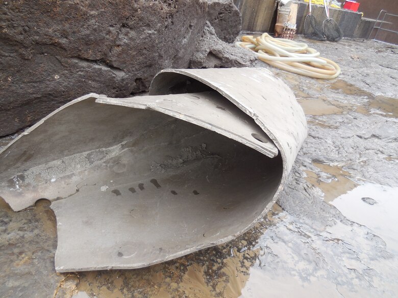 A rolled up piece of steel liner sits in the empty conduit of service gate one of Tuttle Creek Dam.