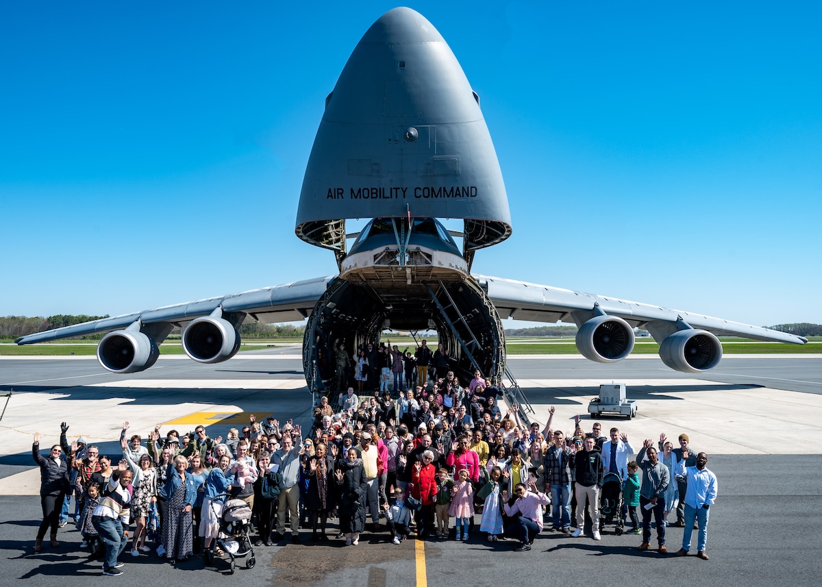 Team Dover members pose for a group photo in front of a C-5M Super Galaxy at Dover Air Force Base, Delaware, April 9, 2023. For the first time since the COVID-19 pandemic, the 436th Airlift Wing Chapel team hosted 130 Team Dover members aboard a C-5 for a religious service. (U.S. Air Force photo by Airman 1st Class Amanda Jett)