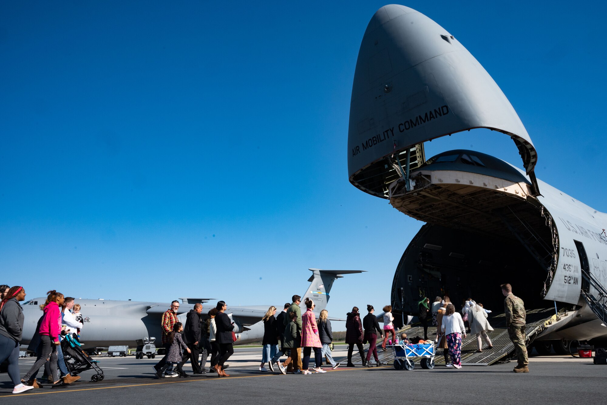 Team Dover members walk up a C-5M Super Galaxy ramp for a religious service at Dover Air Force Base, Delaware, April 9, 2023. For the first time since the COVID-19 pandemic, the 436th Airlift Wing Chapel team hosted 130 Team Dover members aboard a C-5 for a religious service. (U.S. Air Force photo by Airman 1st Class Amanda Jett)