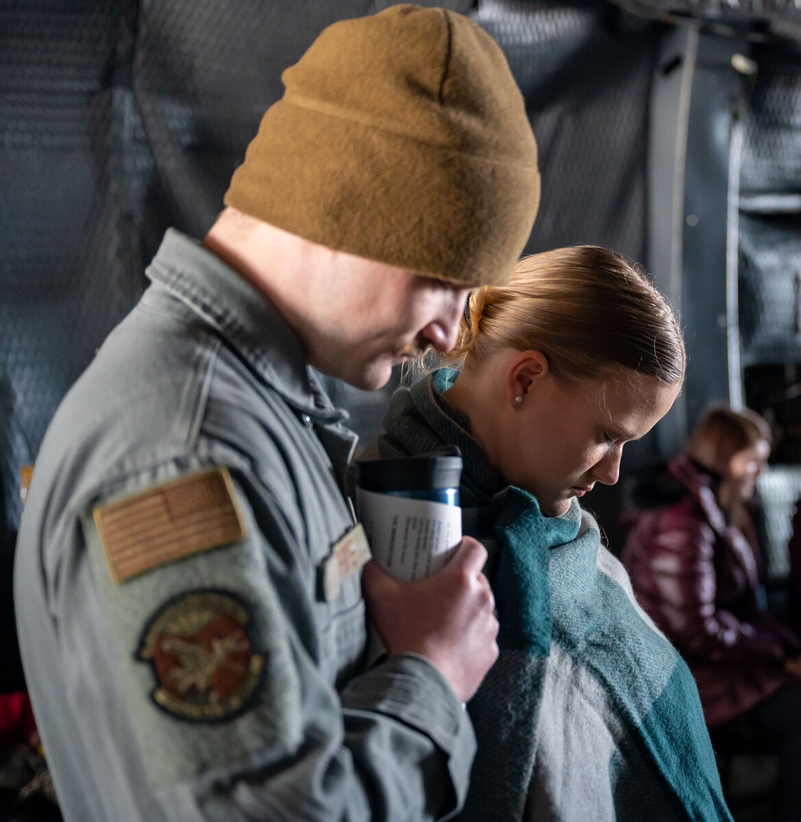 Team Dover members bow their heads in prayer during a religious service aboard a C-5M Super Galaxy at Dover Air Force Base, Delaware, April 9, 2023. For the first time since the COVID-19 pandemic, the 436th Airlift Wing Chapel team hosted 130 Team Dover members aboard a C-5 for a religious service.(U.S. Air Force photo by Airman 1st Class Amanda Jett)