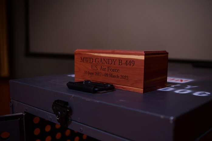 U.S. Air Force MWD Gandy B-449’s cremation box is displayed during the memorial service April 3, 2023, in the Independence Theatre at Beale Air Force Base, California.
