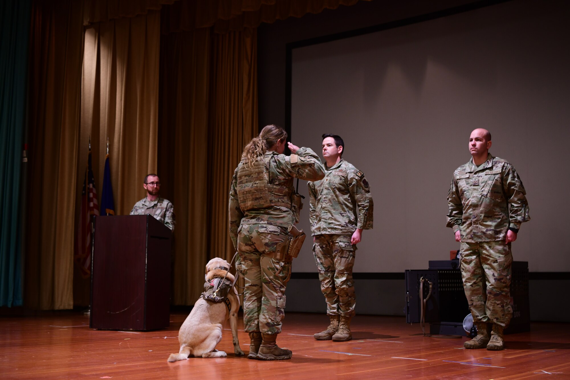 A 9th Security Forces Squadron Military Working Dog (MWD) handler renders a final salute to MDW Gandy B-449 during a memorial ceremony April 3, 2023, at the Independence Theatre on Beale Air Force Base, California.
