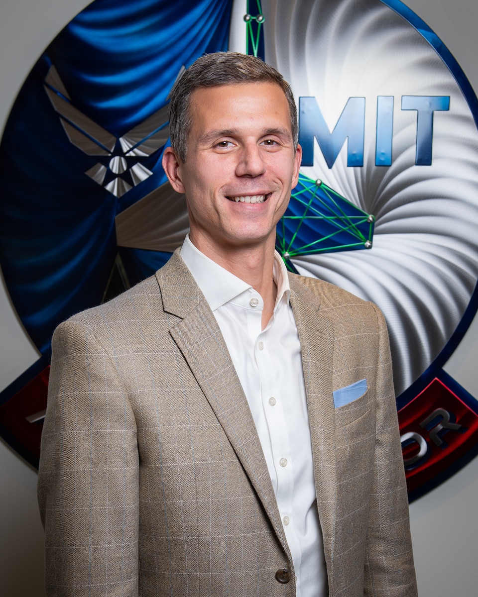 U.S. Air Force Lieutenant Colonel Chris Berardi, Deputy Director, DAF-MIT Artificial Intelligence Accelerator (AIA), poses for a photo at the AIA office, Cambridge, Mass., April 6, 2023. The AI Accelerator leverages universities, small businesses, traditional defense, and non-traditional commercial ventures, collaborating with the Air Force and Space Force to develop and ensure the ethical use of AI technologies for society and the nation. (U.S. Air Force photo by Tech. Sgt. Brycen Guerrero)