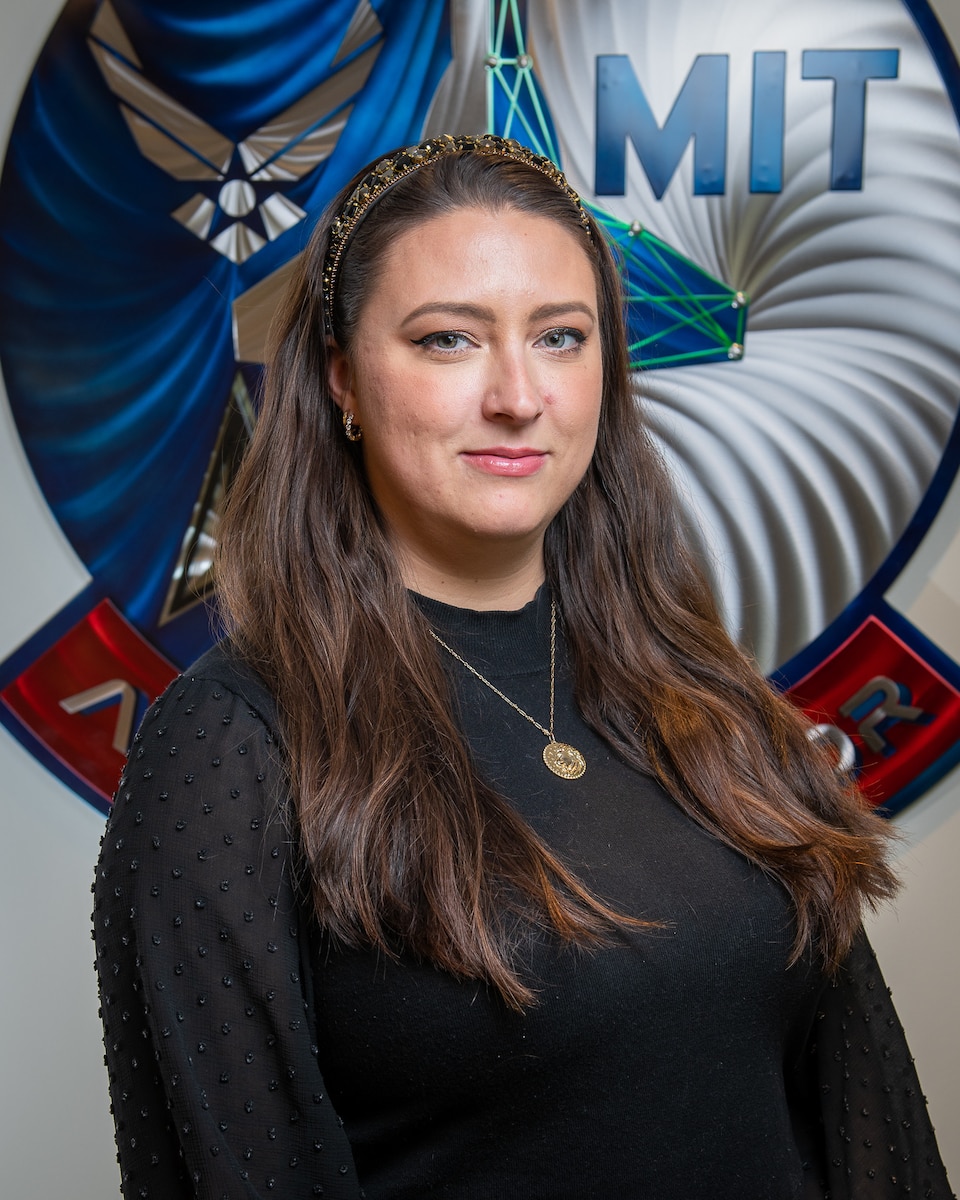 U.S. Air Force Major Stephanie Riley, Cyber Director of Artifical Intelligence Engineering, DAF-MIT Artificial Intelligence Accelerator (AIA), poses for a photo at the AIA office, Cambridge, Mass., April 6, 2023. The AI Accelerator leverages universities, small businesses, traditional defense, and non-traditional commercial ventures, collaborating with the Air Force and Space Force to develop and ensure the ethical use of AI technologies for society and the nation. (U.S. Air Force photo by Tech. Sgt. Brycen Guerrero)