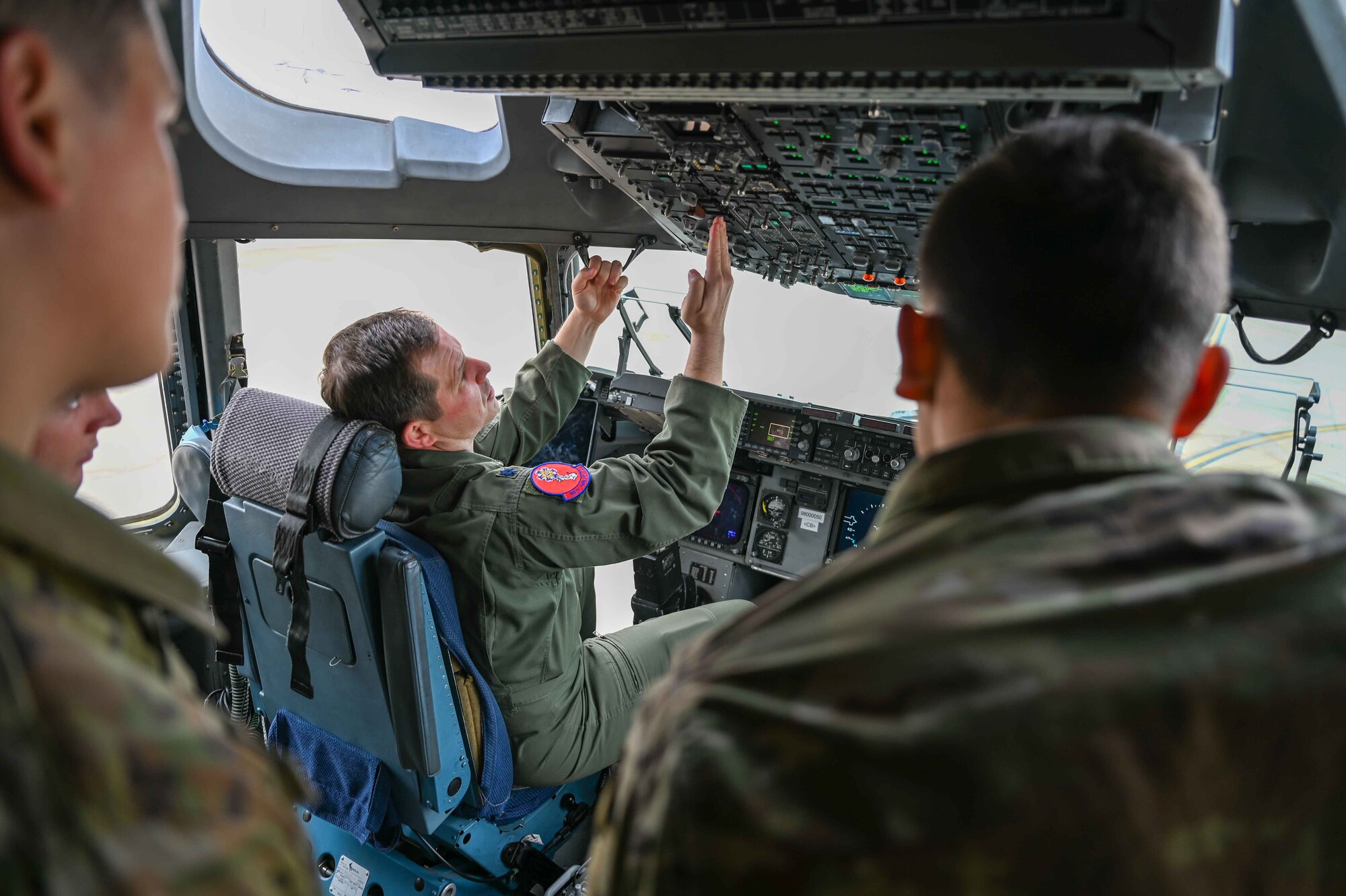 U.S. Air Force Lt. Col. Patrick McLaughlin, 97th Air Mobility Wing director of staff, shows students from the Career Enlisted Aviator (CEA) Center for Excellence the control panels on aC-17 Globemaster III at Joint Base San Antonio-Lackland, April 6, 2023. Students from across the CEA Center for Excellence were invited on to the C-17 and the KC-135 Stratotanker to tour the airplanes and learn from pilots, boom operators, and loadmasters from Altus. (U.S. Air Force photo by Airman 1st Class Kari Degraffenreed)
