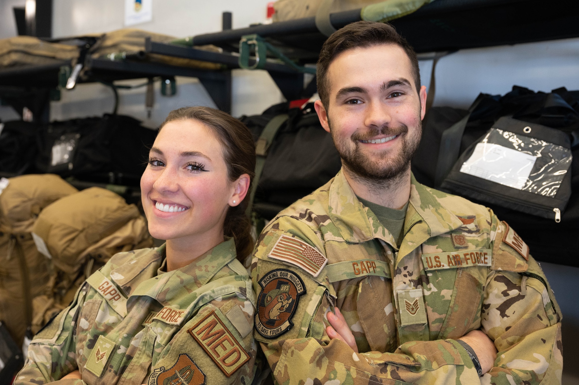 Staff Sgt. Michael Gapp, right, and his sister Senior Airman Amelia Gapp, both 934th Aeromedical Evacuation Squadron technicians, pose for a photo at the Minneapollis-St. Paul Air Reserve Station, Minnesota, April 2, 2023. The Gapp siblings have supported one another since their enlistments and have the rare opportunity to work near each other in service. (U.S. Air Force photo by Senior Airman Victoriya Tarakanova)