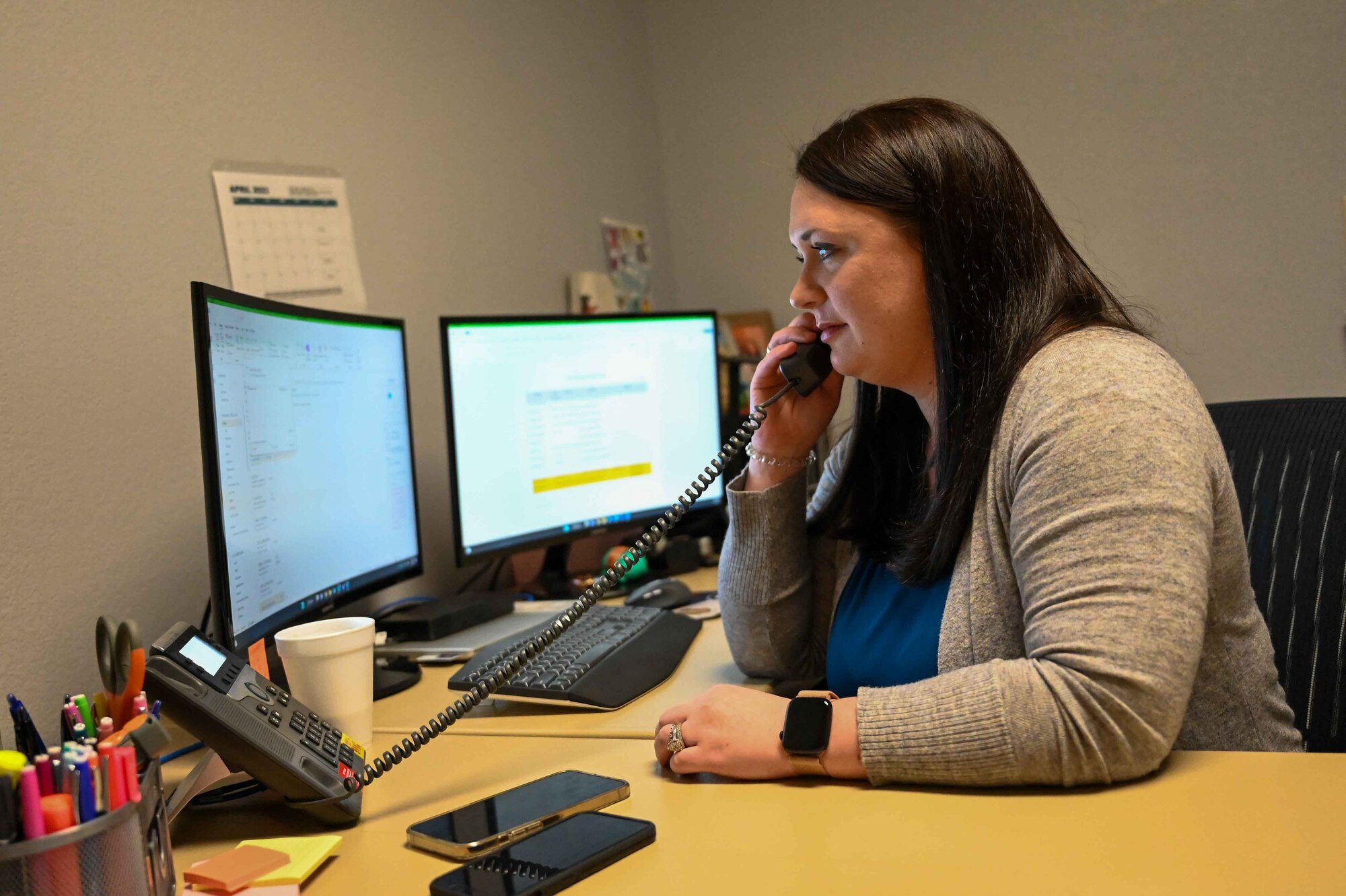 Leah Harris, Sexual Assault Response Coordinator, talks on the phone at Altus Air Force Base, Oklahoma, April 4, 2023. Harris received her Masters degree in human services from Walden University. (U.S. Air Force photo by Airman 1st Class Kari Degraffenreed)
