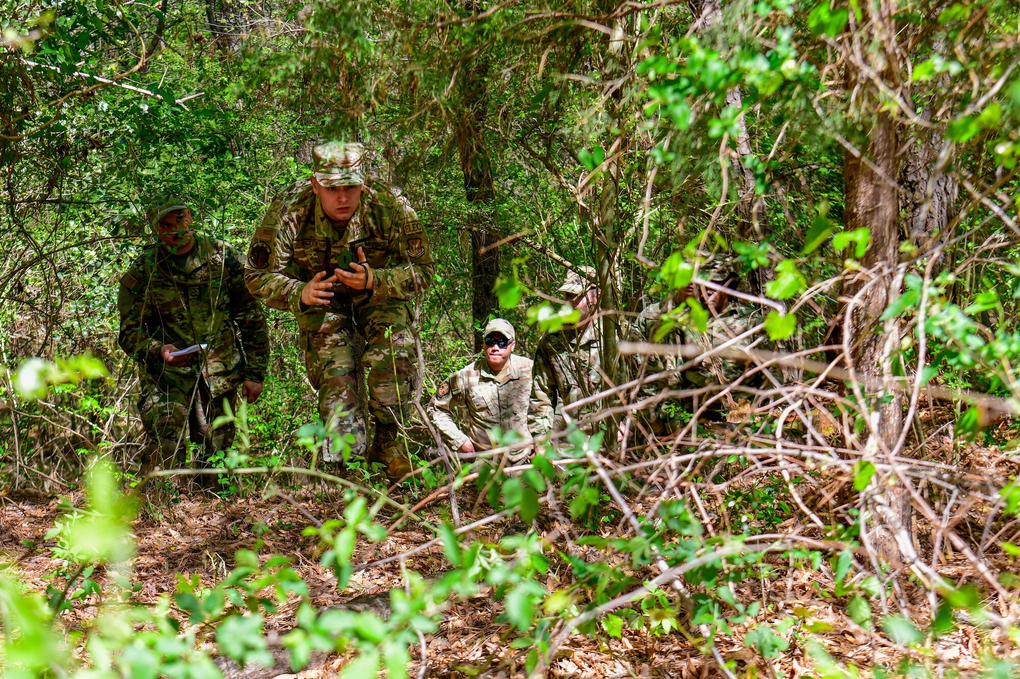 Senior Airman Marcus Figler, an electrical systems journeyman with the 910th Civil Engineer Squadron, navigates his way out of the woods, April 1, 2023, at Dobbins Air Reserve Base, Georgia.