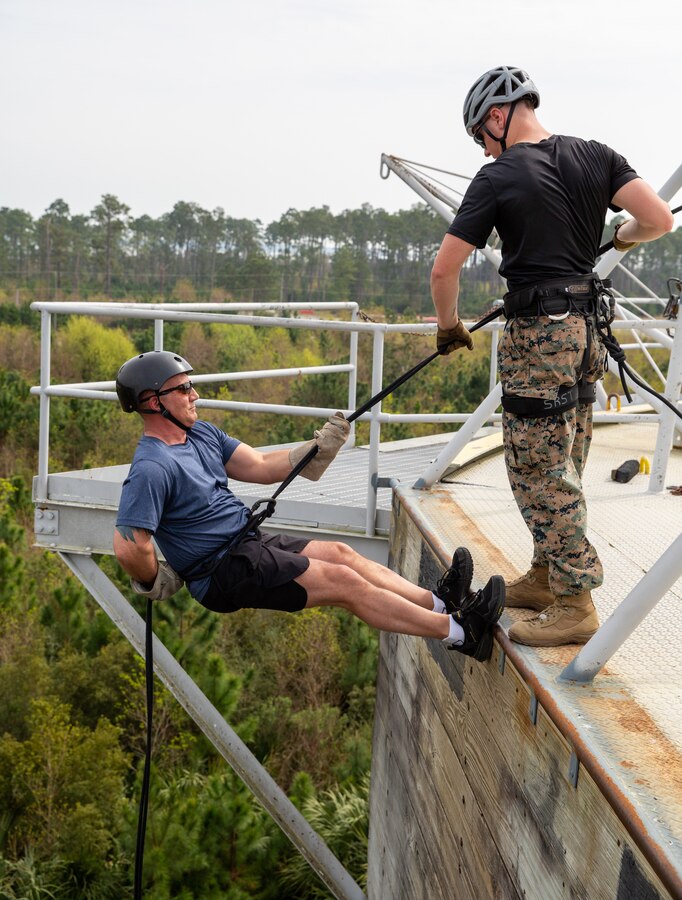 An educator repels down the repel tower during Educators Workshop at Marine Corps Recruit Depot Parris Island, S.C., March 1, 2023.  The purpose of the workshop is to inform high school educators and other key influencers in the community about the process of becoming a United States Marine, and to raise awareness of the opportunities and benefits for qualified individuals in the Marine Corps.  (U.S. Marine Corps photo by Cpl. Bernadette Pacheco)