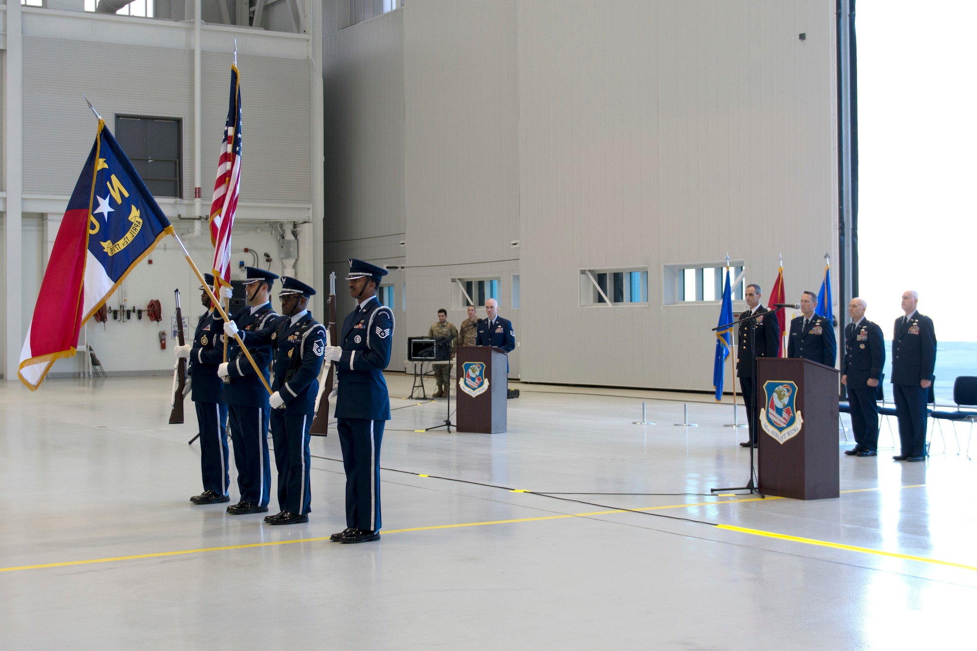 Members of the 145th Airlift Wing honor guard present arms during a ribbon-cutting ceremony held at the North Carolina Air National Guard Base.