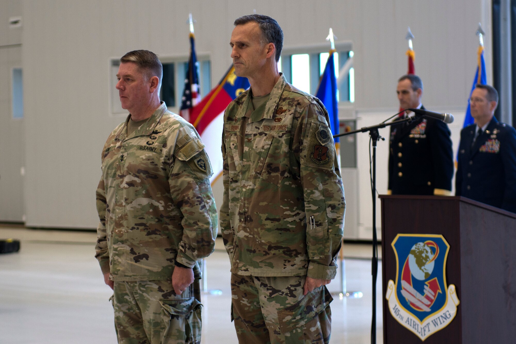 The adjutant general of the North Carolina Guard, Maj. Gen. M. Todd Hunt, and the 145th Airlift Wing Commander Col. Joseph H. Stepp IV anticipate the presentation of the Meritorious Unit award at a ribbon-cutting ceremony at the North Carolina Air National Guard Base.