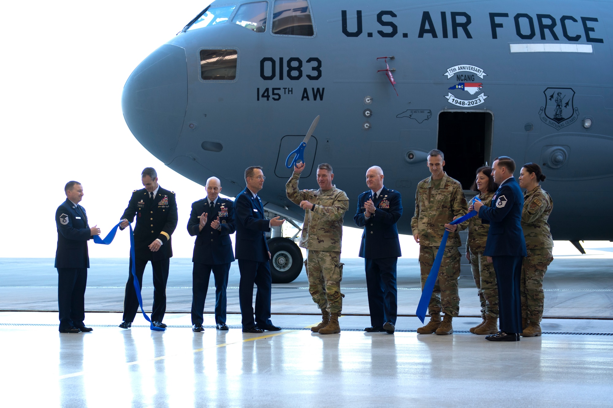 Adjutant general of the North Carolina National Guard Maj. Gen. M. Todd Hunt, celebrates the opening of a new hangar alongside members of the 145th Airlift Wing at the North Carolina Air National Guard