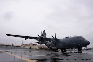 An AC-130J is parked on the flightline
