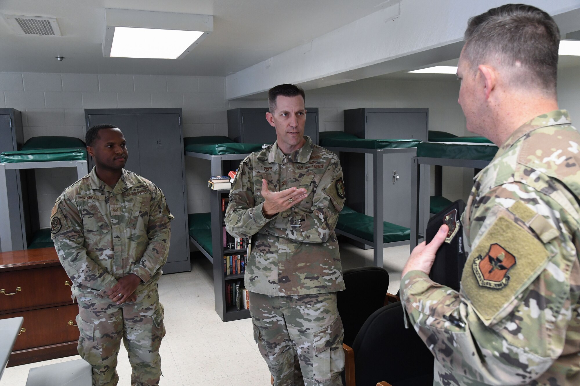 U.S. Air Force Staff Sgt. Cedrick Neal, 81st Security Forces Squadron police services, and Col. Chad Gemeinhardt, 81st Mission Support Group commander, provides Col. Billy Pope, 81st Training Wing commander, with a tour inside the 81st SFS building and an overview of the squadron's mission and capabilities during the 81st MSG Immersion Tour at Keesler Air Force Base, Mississippi, April 7, 2023.
