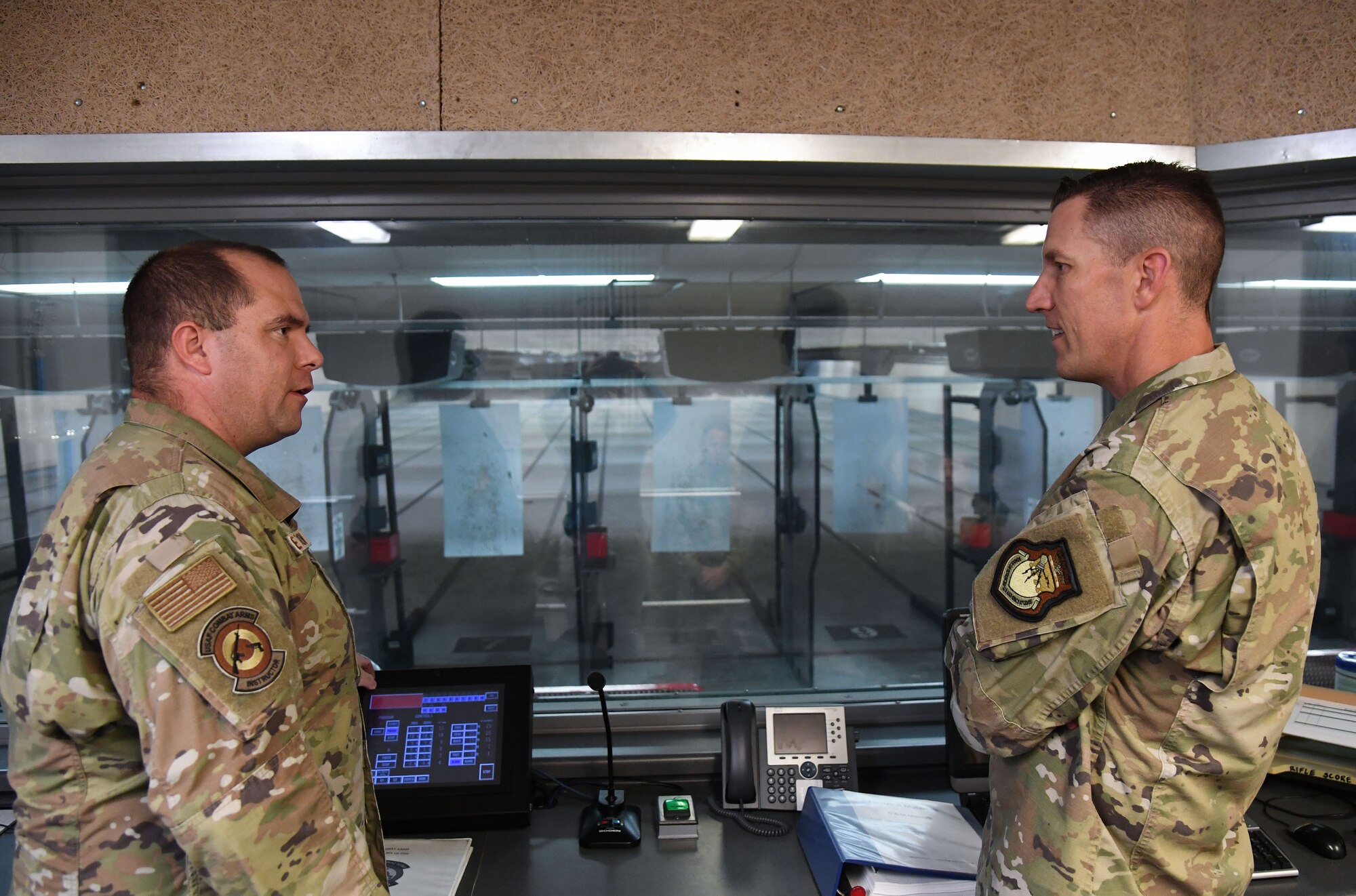 U.S. Air Force Staff Sgt. Jesse Peterson, 81st Security Forces Squadron combat arms NCO in charge, provides Col. Billy Pope, 81st Training Wing commander, with a tour inside the 81st SFS indoor firing range during the 81st MSG Immersion Tour at Keesler Air Force Base, Mississippi, April 7, 2023.