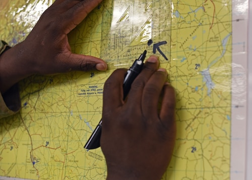 U.S. Air Force Airman 1st Class Marquan Pollock, 315th Training Squadron student, plots a point at Goodfellow Air Force Base, Texas, April 7, 2023. The geospatial intelligence analyst course progresses to teach students to gather data, analyze data in real-time, and hone their briefing skills. (U.S. Air Force photo by Senior Airman Sarah Williams)