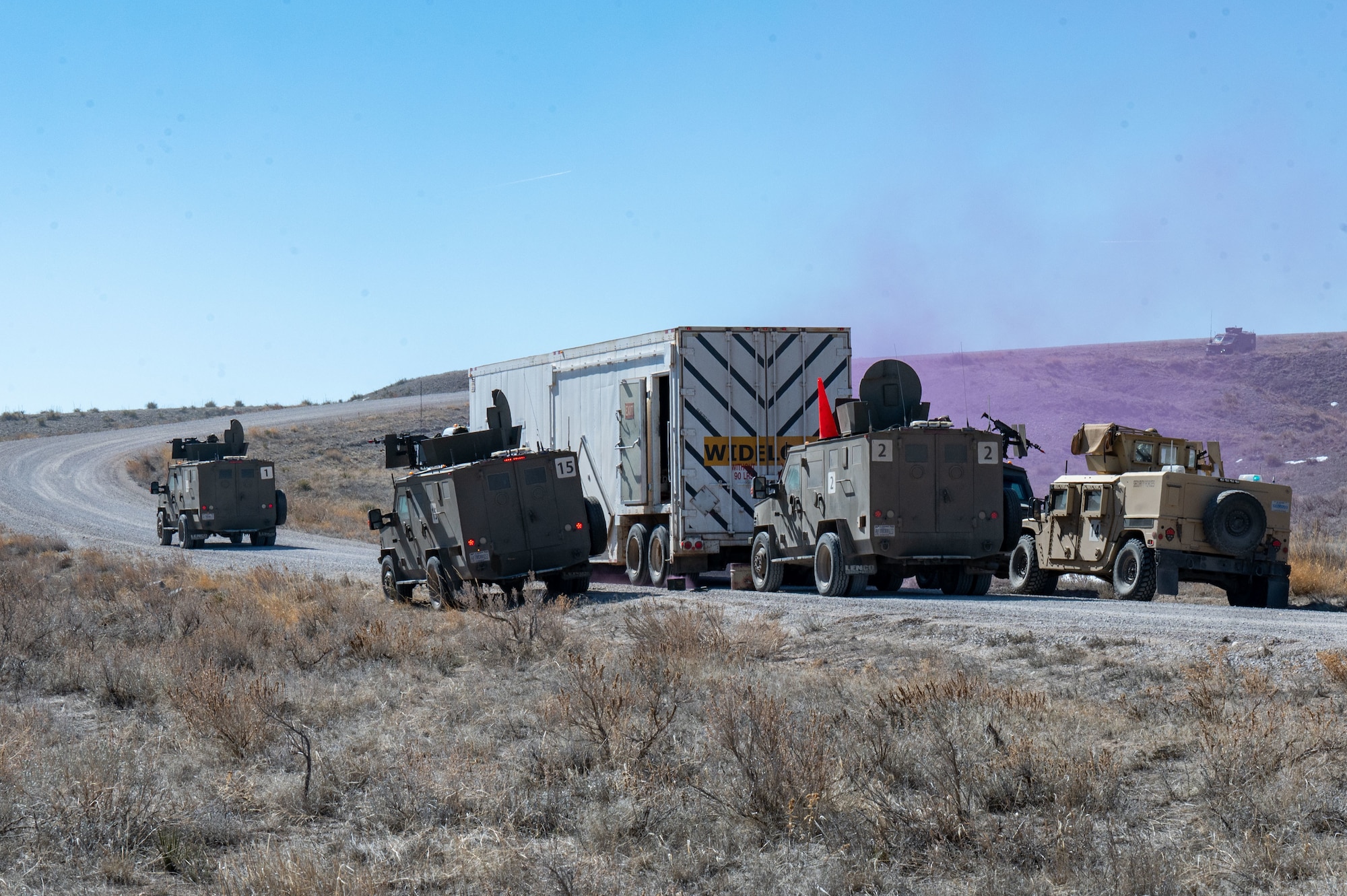 opposing force members move on a convoy