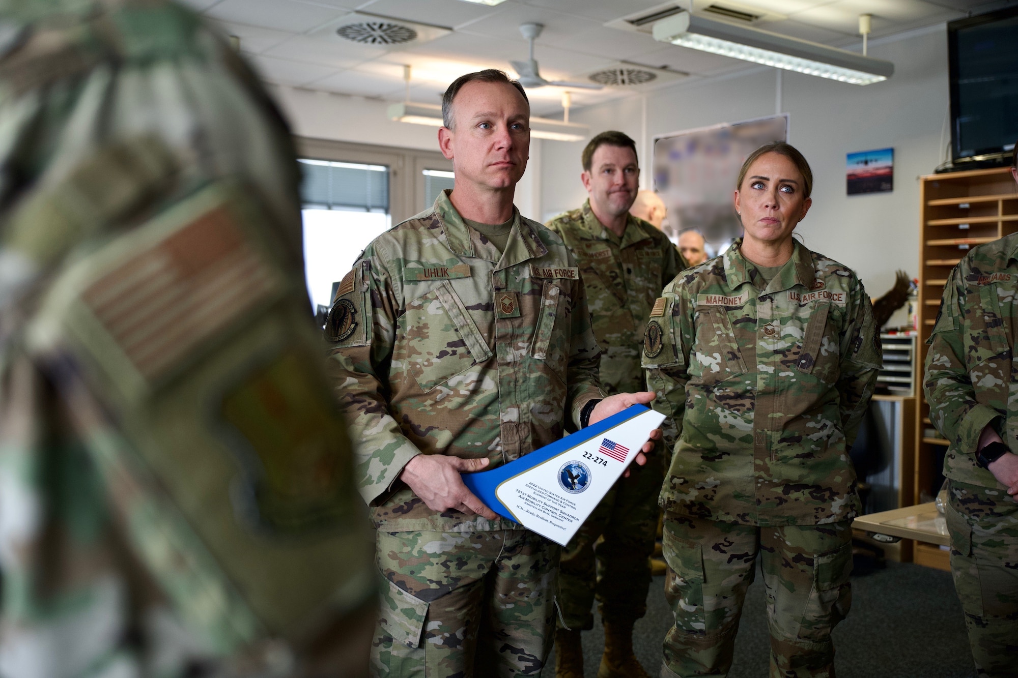 Master Sgt. Anthony Uhlik (left), 721st Mobility Support Squadron command and control operations superintendent, and Master Sgt. Angeline Mahoney (right), 721st Mobility Support Squadron senior enlisted leader, speak with the 521st Air Mobility Operations Wing command team on Ramstein Air Base, Germany, March 20, 2023.