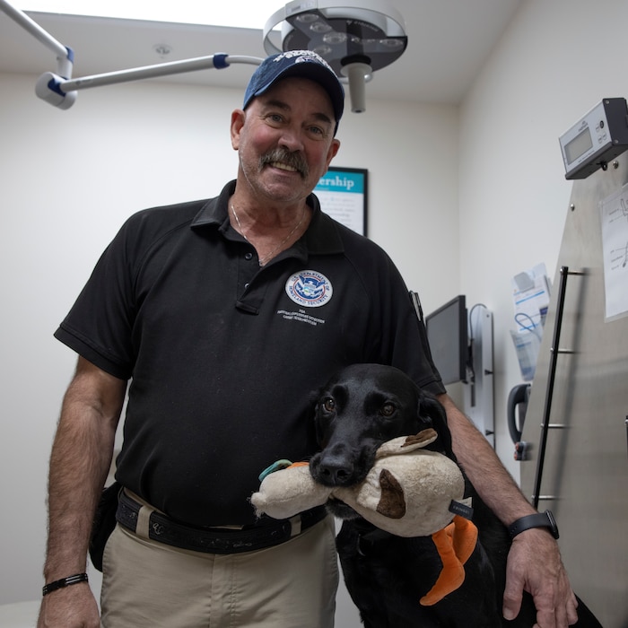 Man and dog pose for photo