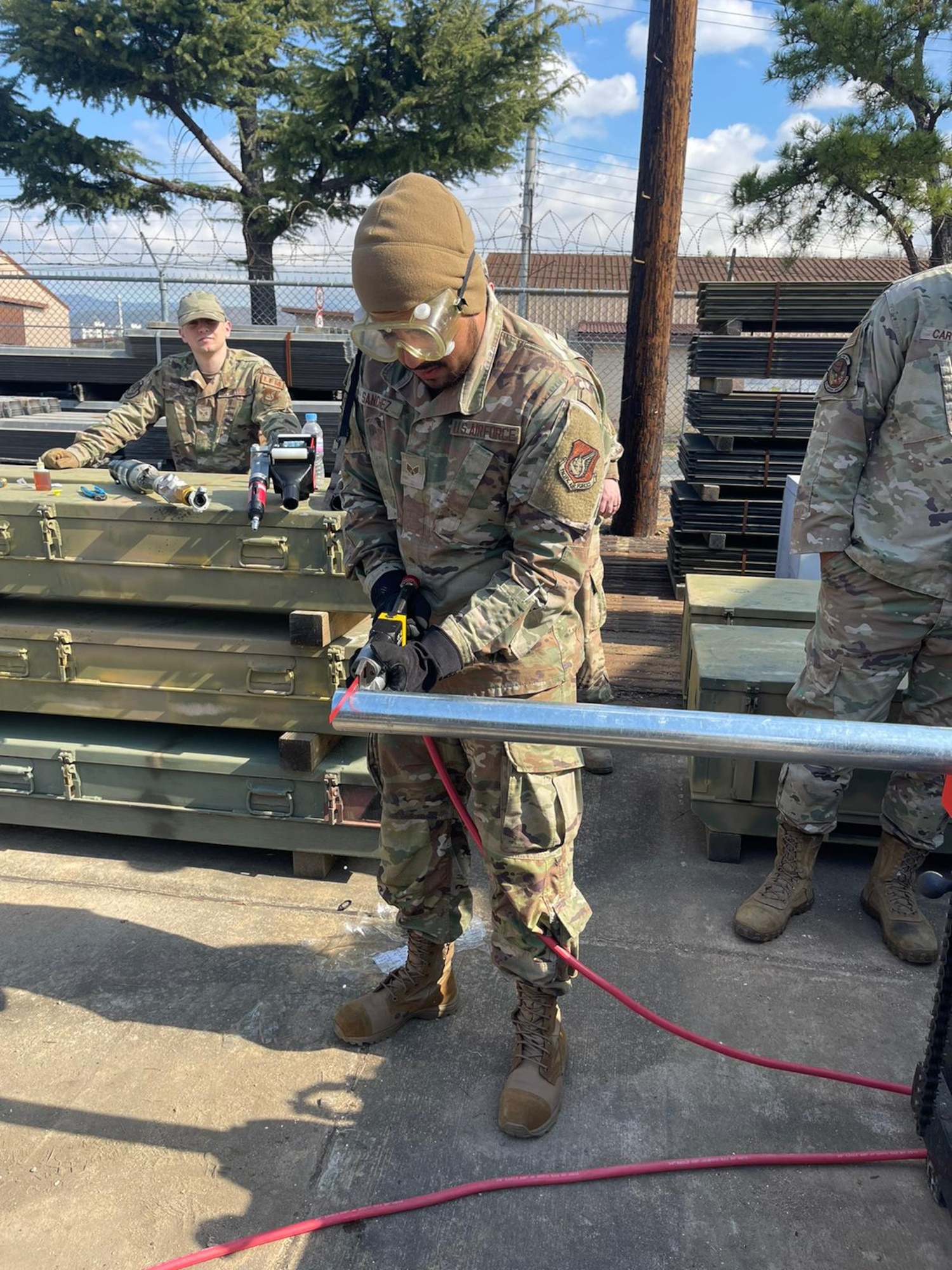 U.S. Air Force Senior Airman Sabian Sanchez, 51st Civil Engineer Squadron water and fuels system maintenance journeyman, utilizes a pneumatic hand saw to
cut a pipe during a course at Daegu Air Base, Republic of Korea March 13-16, 2023.