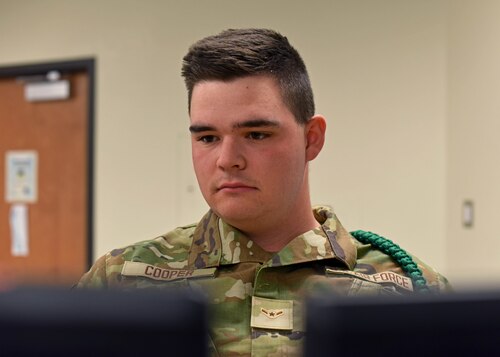 U.S. Air Force Airman Matthew Cooper, 315th Training Squadron student, concentrates on imagery at Goodfellow Air Force Base, Texas, April 7, 2023. Geospatial intelligence analysts go through a five-month training course learning fundamentals such as intelligence community partners, operational structure, and the capability limitations of sensors they will work with in the operational field. (U.S. Air Force photo by Senior Airman Sarah Williams)