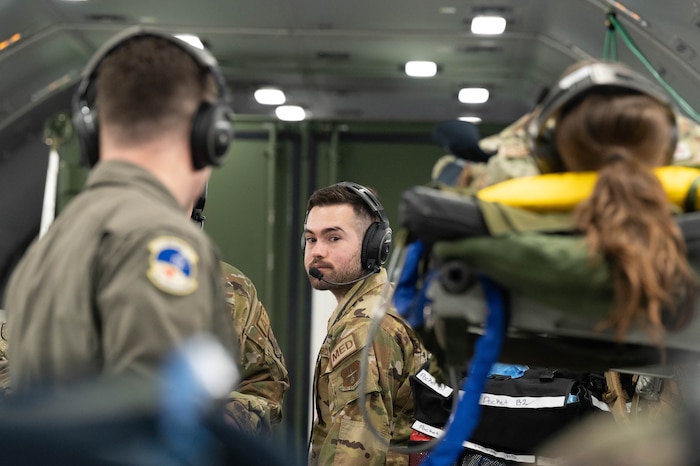 Staff Sgt. Michael Gapp, a 934th Aeromedical Evacuation Squadron technician, assists his team members aboard an aircraft over the Atlantic Ocean on March 27, 2023. Gapp went with other squadron members on a three-day exercise to the Virgin Islands. (U.S. Air Force photo by Senior Airman Victoriya Tarakanova)