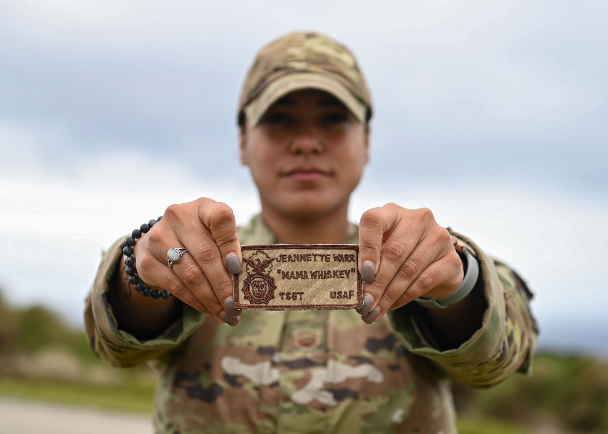 Senior Master Sgt. Jeannette Warr, 36th Wing Equal Opportunity director, proudly shows the defender patch she once wore before retraining in 2014, at Andersen Air Force Base, Guam, April 6, 2023. Warr joined the Air Force in 2004, receiving security forces as her first career specialty. Early on in her career, Warr realized there was no female representation at any level within the security forces career field and she decided she wanted to be the change her career field needed. (U.S. Air Force photo by Staff Sgt. Aubree Owens)
