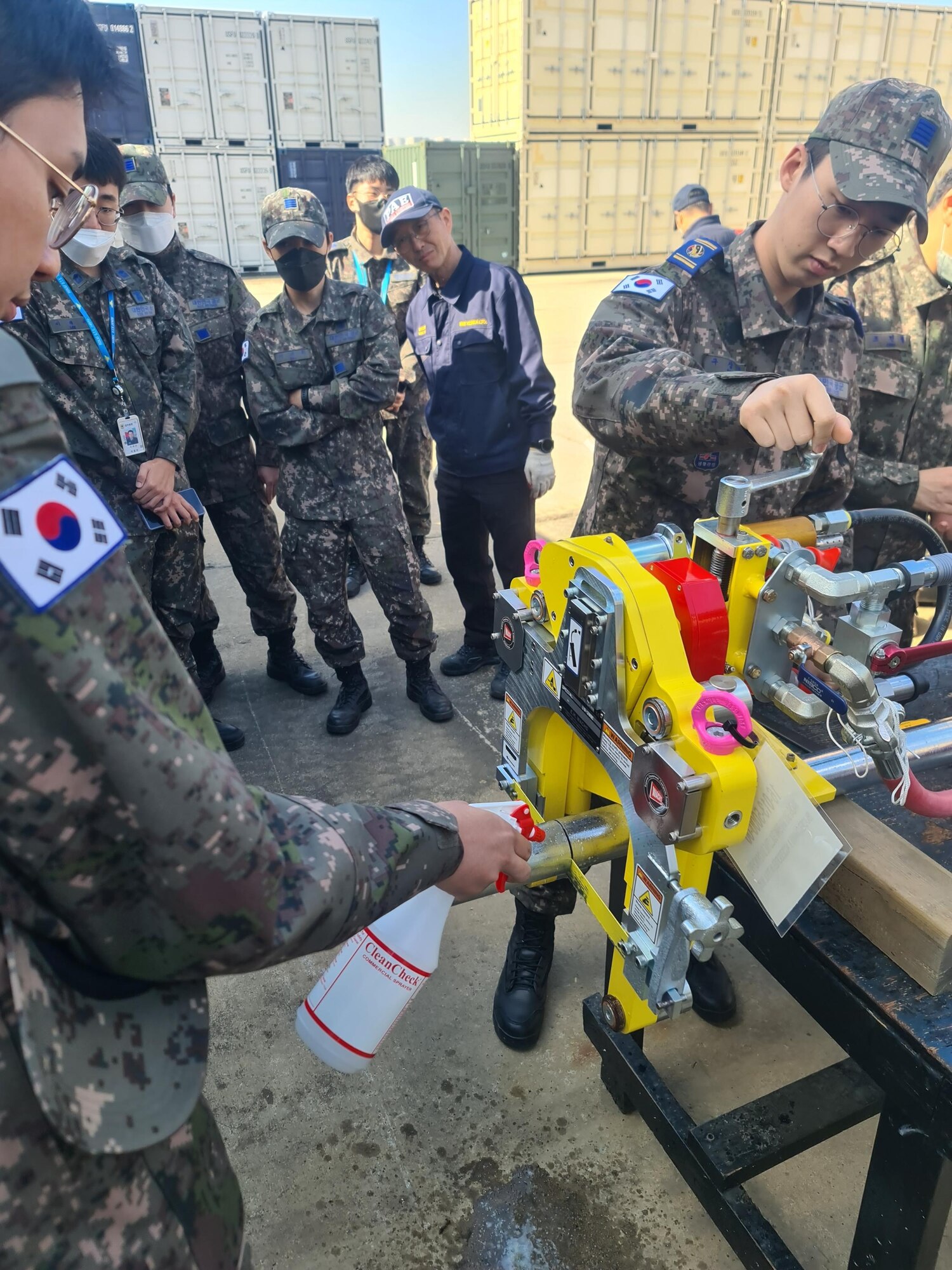 U.S. Air Force Tech. Sgt. Travis Reed, 554th Rapid Engineer Deployable Heavy Operational Repair Squadron Engineer silver flag instructor, and Tech. Sgt. Thao Chau, 554th Rapid Engineer Deployable Heavy Operational Repair Squadron Engineer silver flag instructor, demonstrate how to use a guillotine saw during a training course at Daegu Air Base, Republic of Korea, March 13-16, 2023.