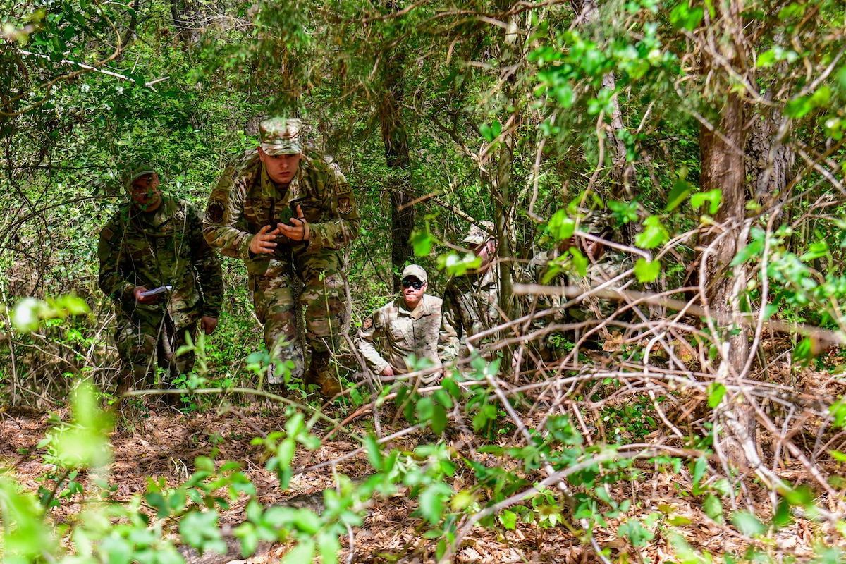 Senior Airman Marcus Figler, an electrical systems journeyman with the 910th Civil Engineer Squadron, navigates his way out of the woods, April 1, 2023, at Dobbins Air Reserve Base, Georgia.