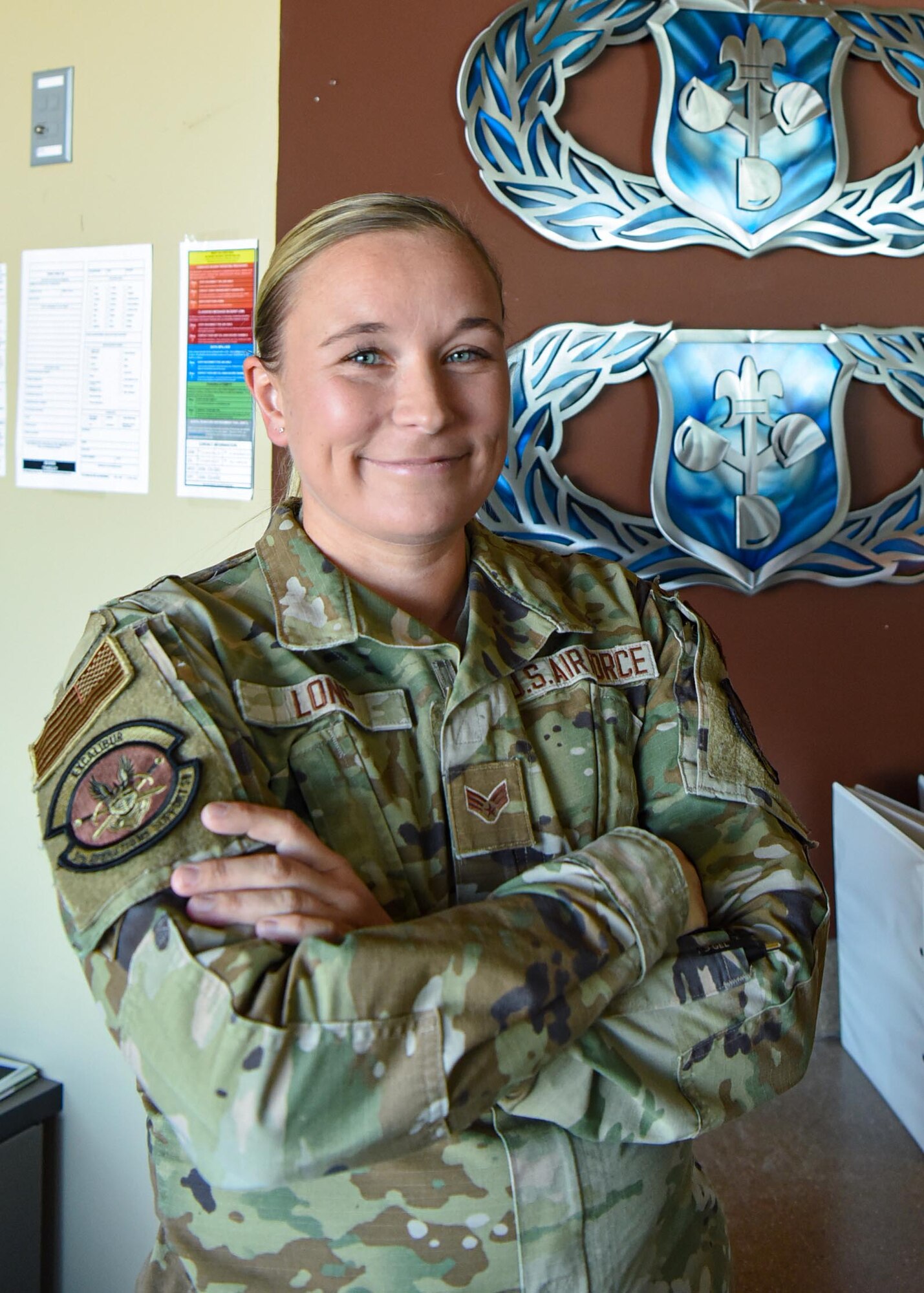 Senior Airman Christina Long, 5th Operations Support Squadron weather forecaster, poses for a photo in her office at Minot Air Force Base, North Dakota, April 7, 2023. A weather Airman’s duties primarily involve integrating current and forecasted atmospheric and space weather conditions into operations and planning.  (U.S. Air Force photo by Senior Airman Caleb S. Kimmell)