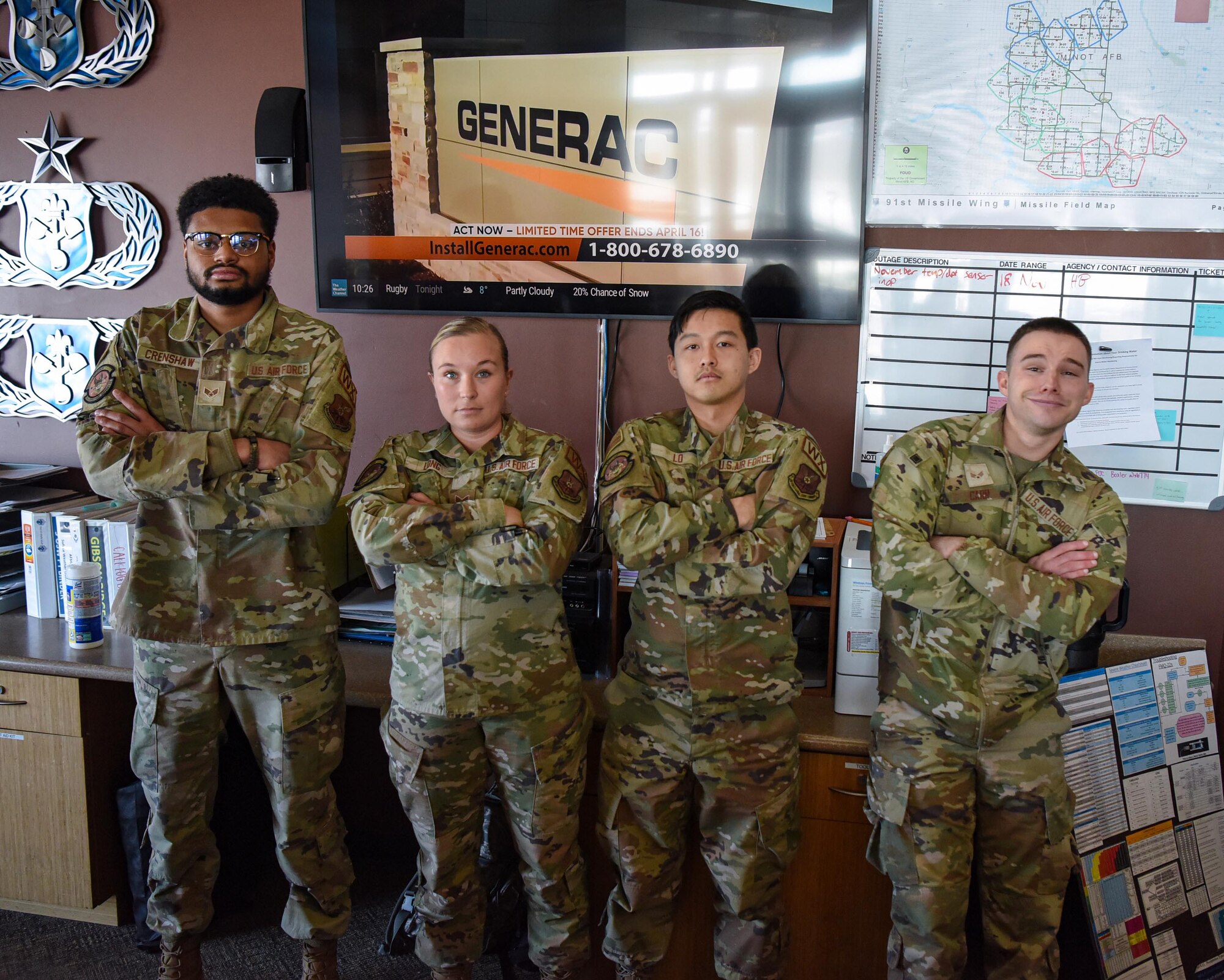 Senior Airman Christina Long, 5th Operations Support Squadron weather forecaster (center left), poses for a photo with her team at Minot Air Force Base, North Dakota, April 7, 2023. A weather Airman’s duties primarily involve integrating current and forecasted atmospheric and space weather conditions into operations and planning.  (U.S. Air Force photo by Senior Airman Caleb S. Kimmell)