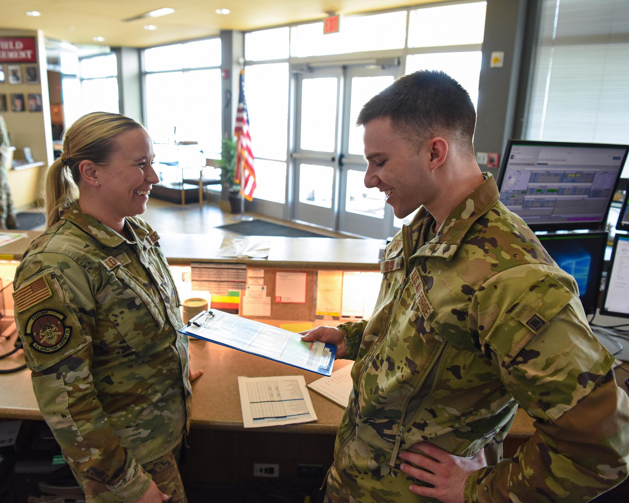 Senior Airman Christina Long (left) and Senior Airman Colt Carr, 5th Operations Support Squadron weather forecaster, go over weather data at Minot Air Force Base, North Dakota, April 7, 2023. Weather specialists keep a constant watch over the forecast and conditions that can affect the safety of pilots and aircrew. (U.S. Air Force photo by Senior Airman Caleb S. Kimmell)