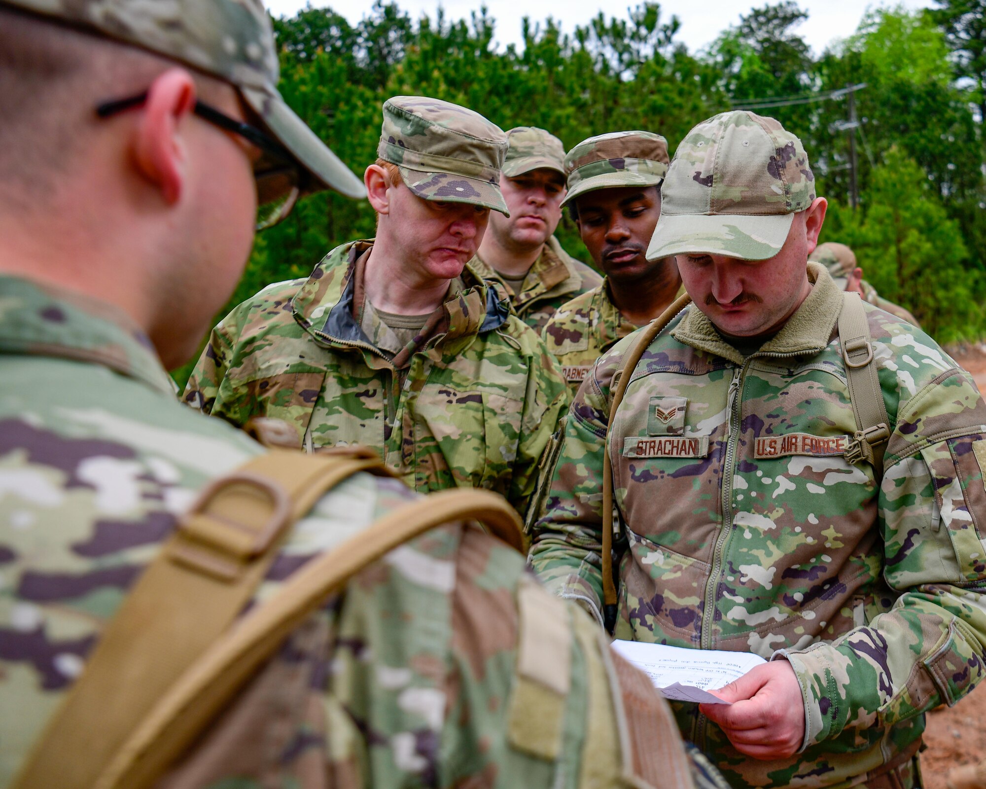 Staff Sgt. Hunter Schwab, a fireteam member with the 910th Security Forces Squadron, teaches Reserve Citizen Airmen assigned to the 910th Civil Engineer Squadron how to use a standard range card, April 1, 2023, at Dobbins Air Reserve Base, Georgia.