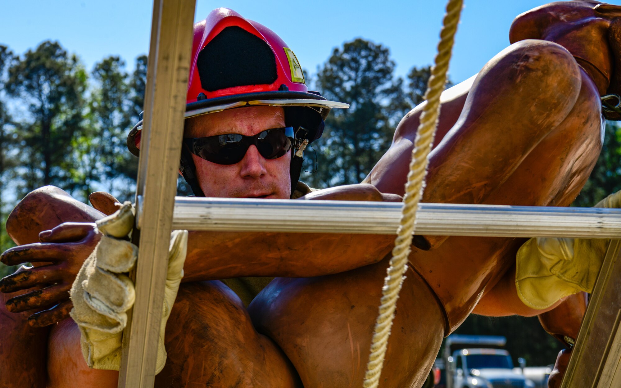 Tech. Sgt. Justin Ross, a firefighter with the 910th Civil Engineer Squadron, carries a fire and rescue service manikin down a ladder, March 30, 2023, at Dobbins Air Reserve Base, Georgia.