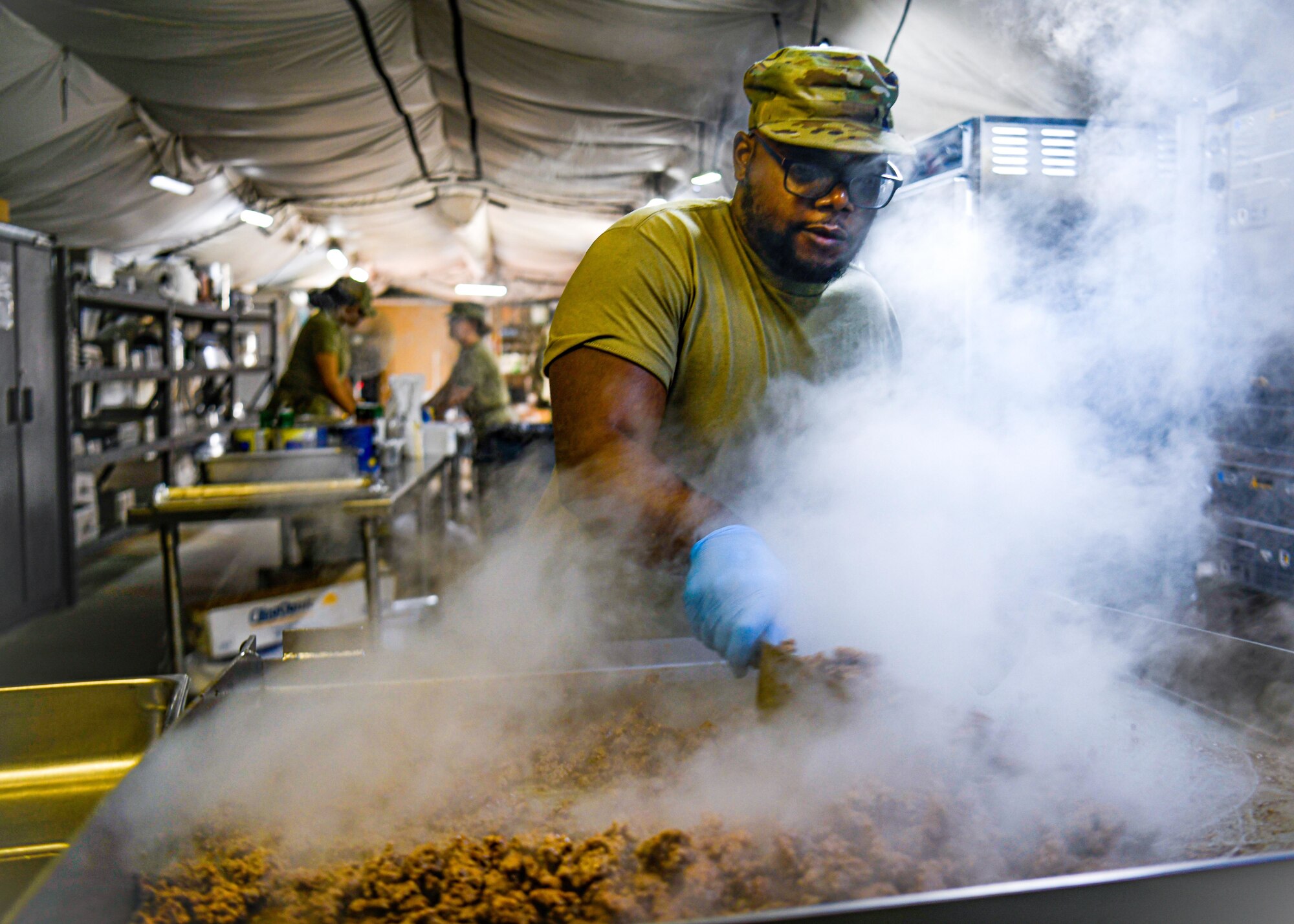 Senior Airman Devonte Whatley, a sustainment service specialist with the 910th Force Support Squadron, prepares lunch in a field kitchen, March 31, 2023, at Dobbins Air Reserve Base, Georgia.
