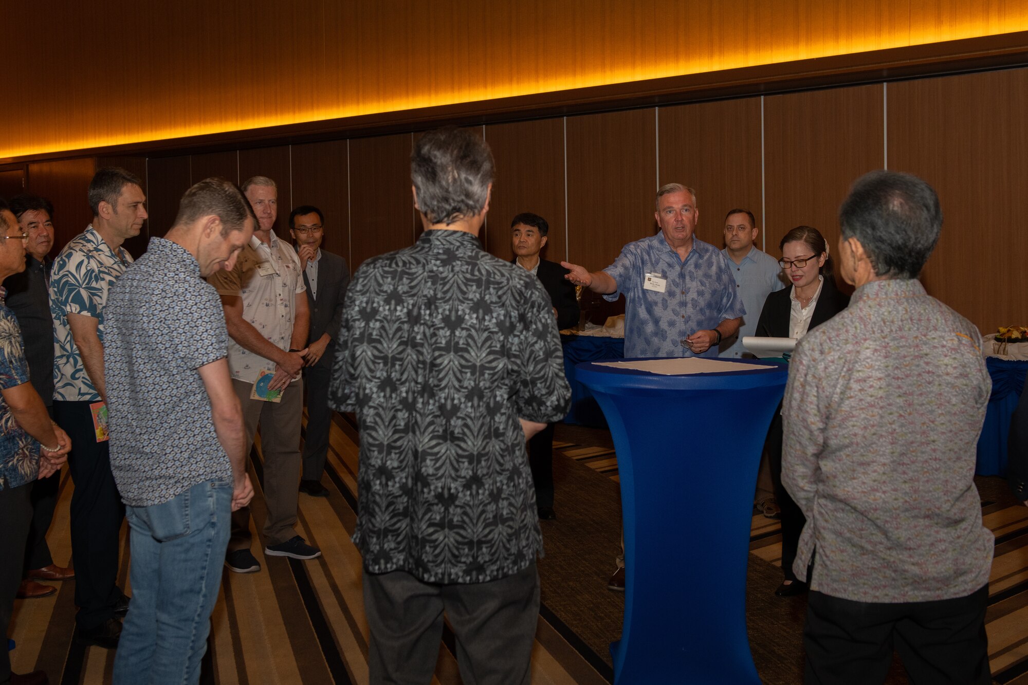 Airmen and local leaders listen to a speaker.