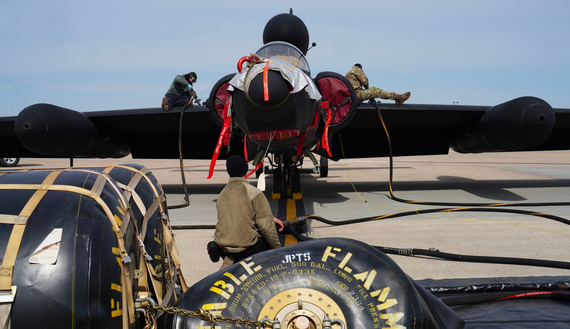 A U.S. Air Force 9th Aircraft Maintenance Squadron crew chief, left, 9th AMXS dedicated crew chief, and 9th AMXS airframe reclamation technician fuel a U-2 Dragon Lady, March 29, 2023, at Offutt Air Force Base, Nebraska.