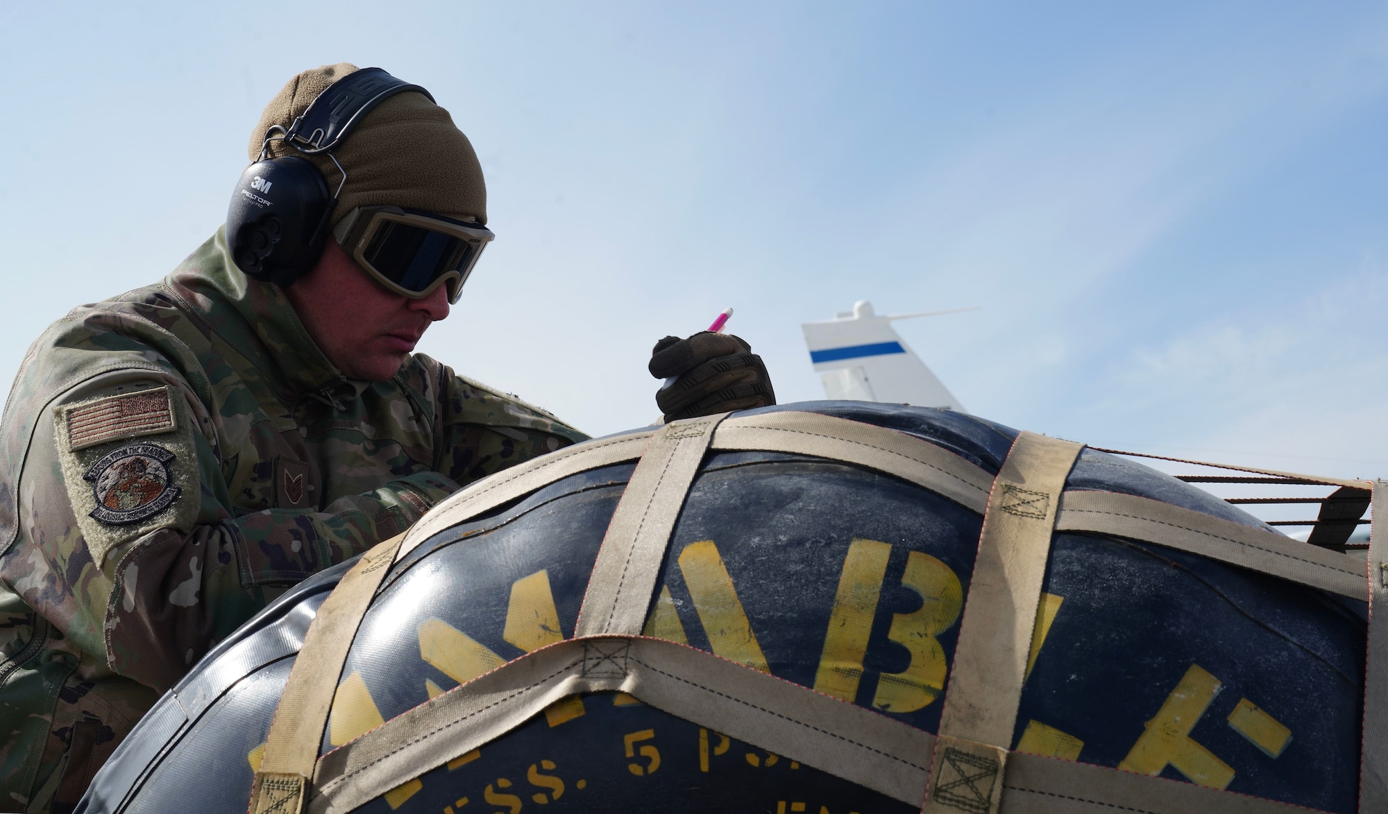 A U.S. Air Force 9th Logistics Readiness Squadron immediate response force program manager reviews paperwork on a blivet full of fuel, March 29, 2023, at Offutt Air Force Base, Nebraska.